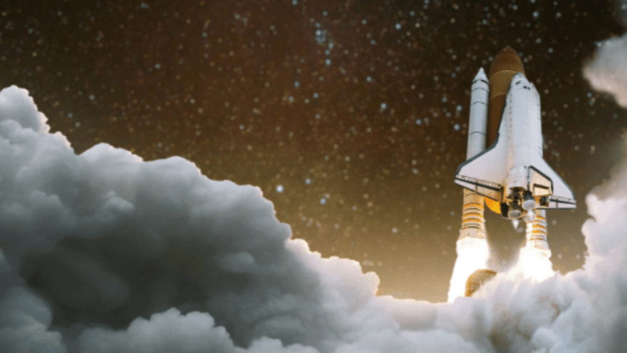 Space Shuttle launching into the night sky