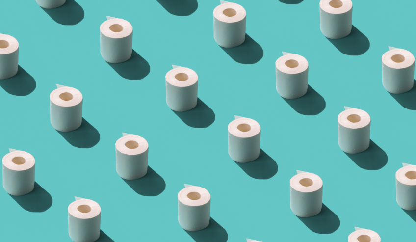 Tissue rolls laid on a mint green surface