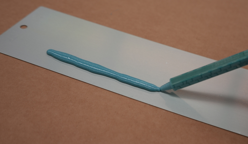 Applying silicone adhesive on a metal surface