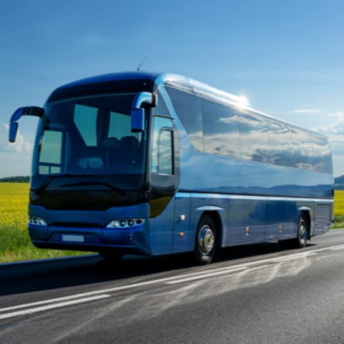 Bus traveling on road on a sunny day