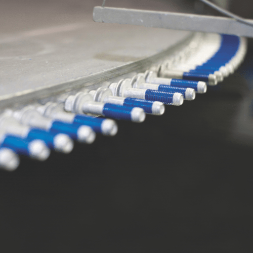 Screw nuts in blue on an assembly line