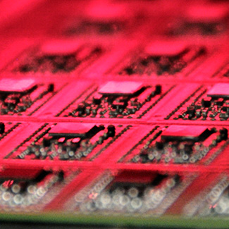 Close up image of printed circuit board under red light