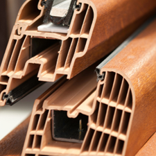 Window profile wrapped in brown wooden textured laminate