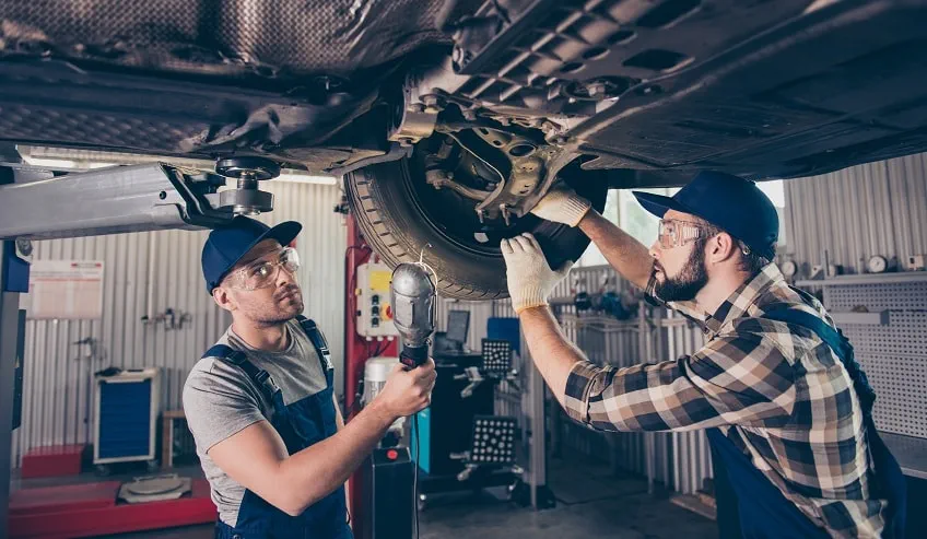 Mechanics working on a car.