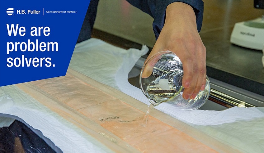 Image of Liquid Being Poured on Diaper Core.