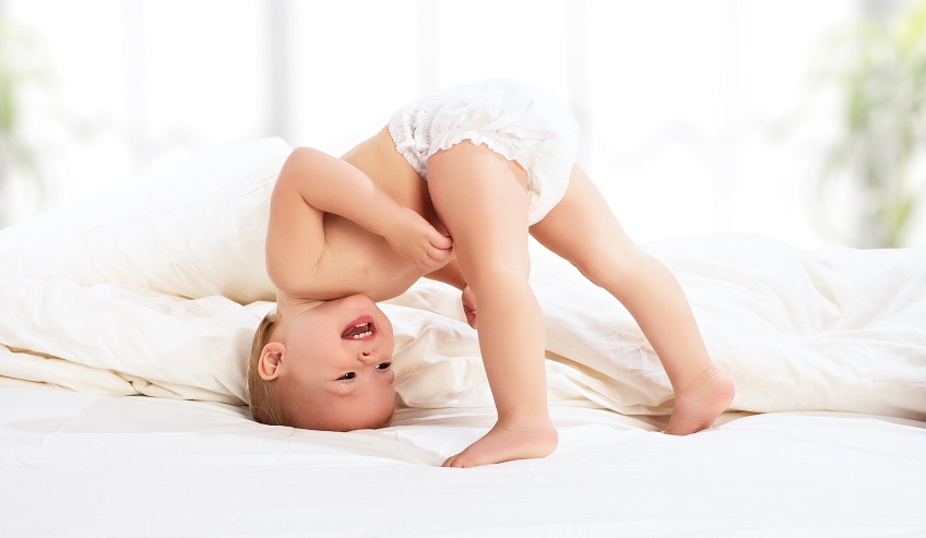 happy baby child play fun in bed