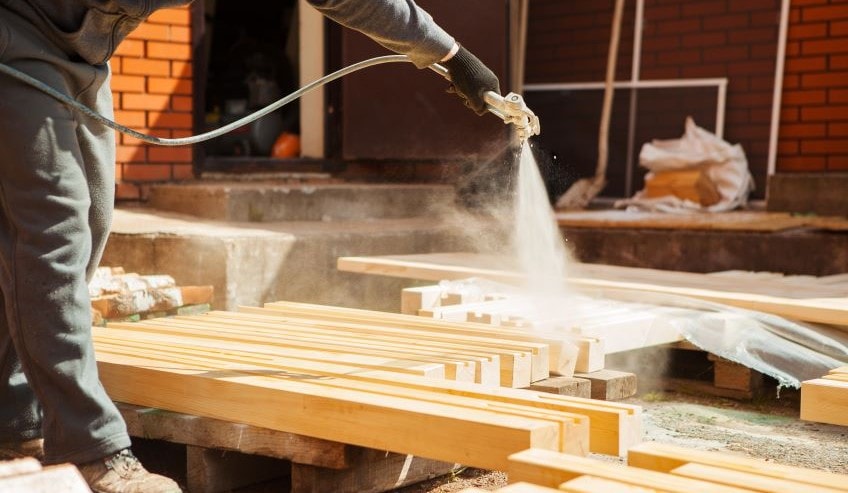 Spraying fire retardant on wood