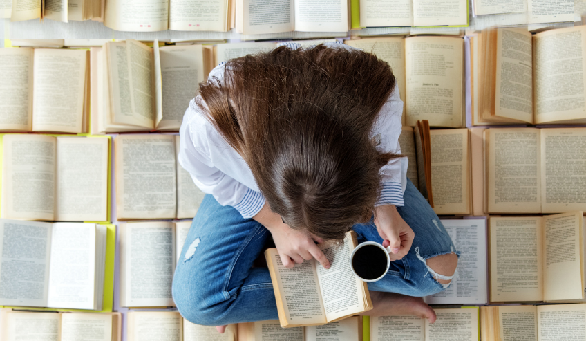 Woman reading book with coffee