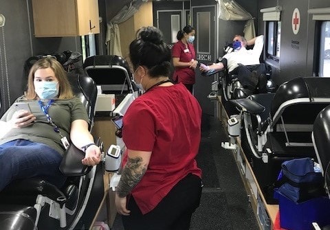 Volunteer giving blood at a blood drive for American Red Cross