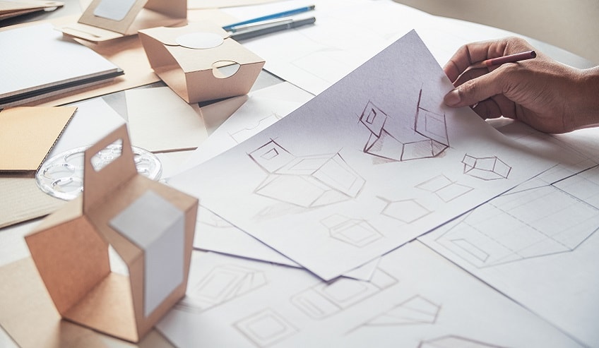 Designer drawing sketches of fit for purpose packaging.