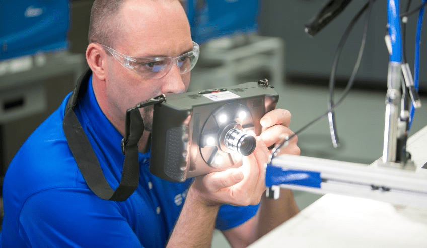 Man using high tech camera in lab setting