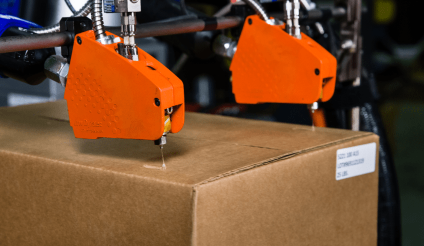 Hot melt being applied to a box