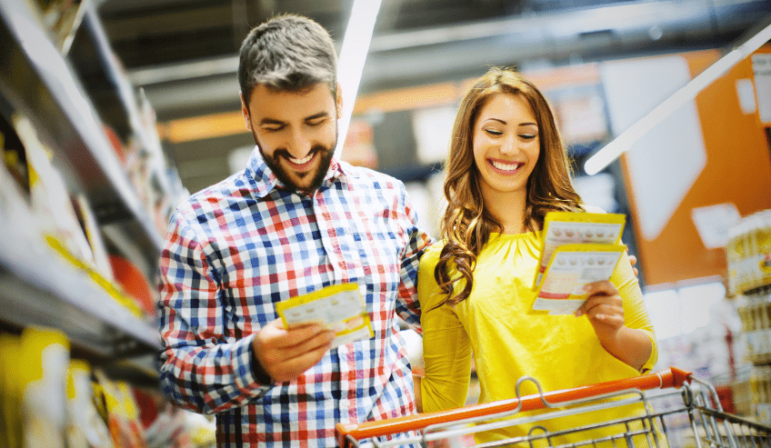 Happy couple buying flexible food pouches at the supermarket