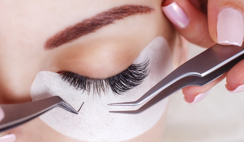 Artificial eyelash application on a female