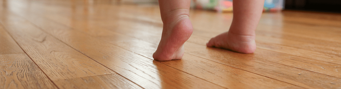 toddler on wooding floor