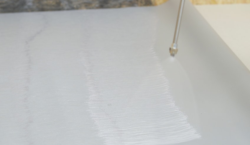 Adhesives being sprayed on surface